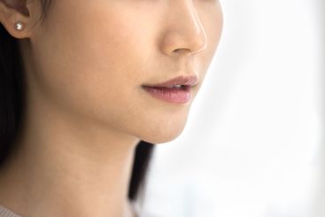 Close up shot of young beautiful Asian womans lower face