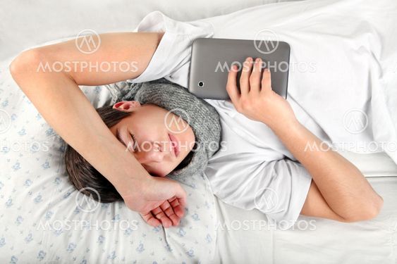 Young Man sleeps with Tablet Computer