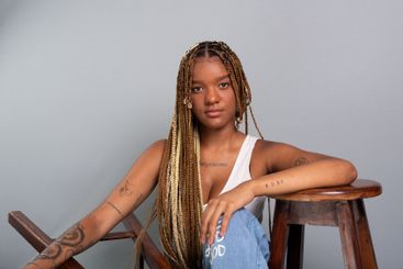 Beautiful brunette woman with braids in her hair,...