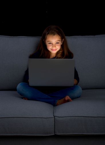 Little girl working with a laptop