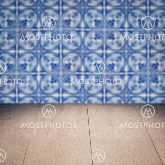 Wood table top and blur vintage ceramic tile pattern wall