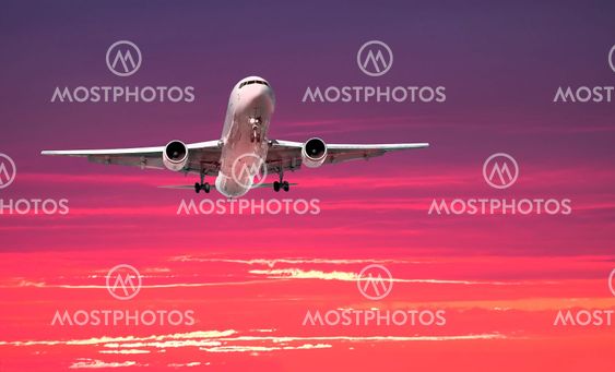 Large jet arriving at sunset