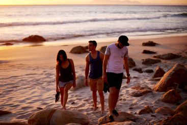 People, sunset and walk at ocean for travel, summer...