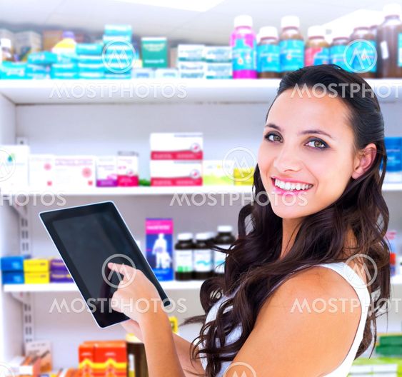 Composite image of pretty brunette using tablet pc