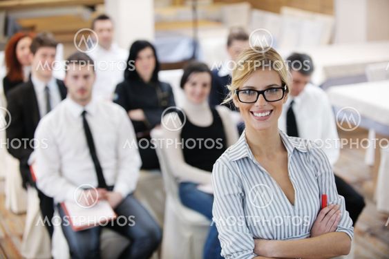 business woman standing with her staff at conference