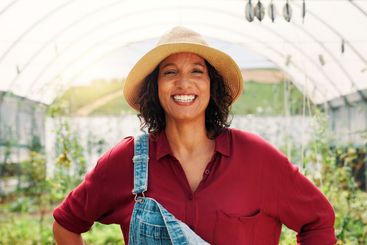 Happy, greenhouse and portrait of woman on farm with...