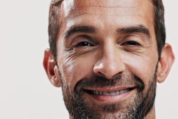 Portrait, smile and man for skincare in studio of facial...