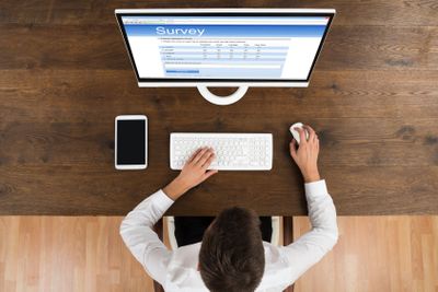 Businessman Filling Survey Form On Computer