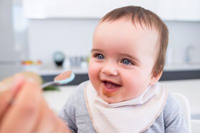 Baby boy being fed by mother