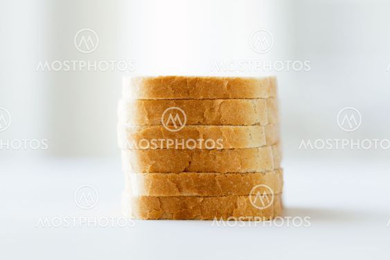 close up of white sliced toast bread pile on table