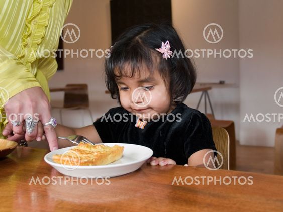Little Native American girl eating quiche