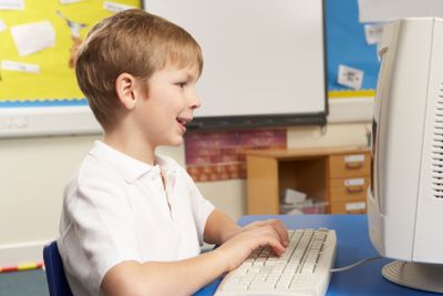 Schoolboy In IT Class Using Computer