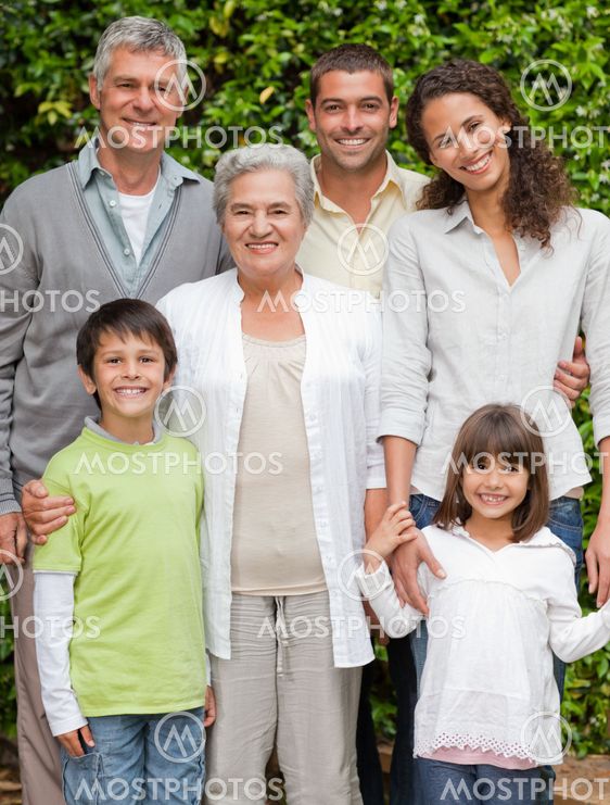 Portrait of a happy family looking at the camera in the garden
