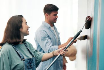 Couple, project and painting a wall in home for diy...