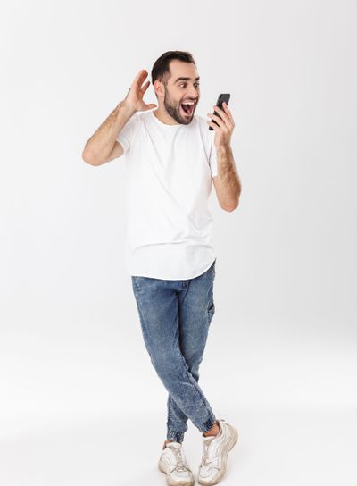 Full length of a handsome cheerful man wearing blank...