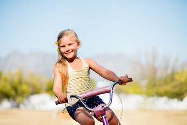 Girl, child and outdoor for riding bike, learning...
