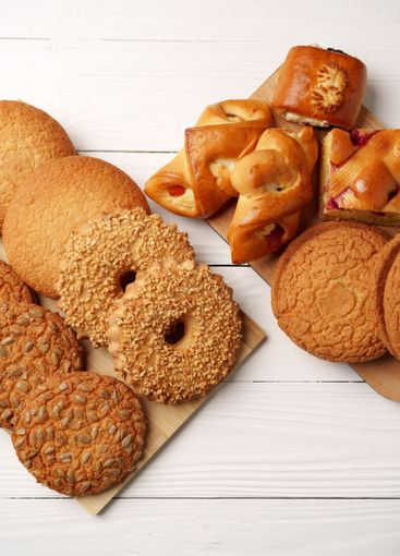 Various types of baked cookies and pastries arranged on...