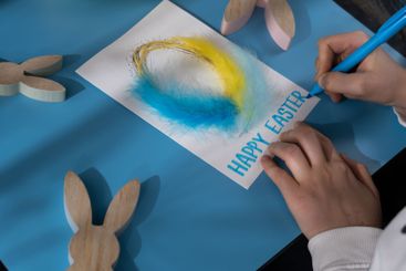 Creating Easter egg with cotton rope and colorful...