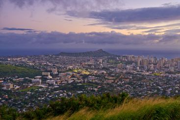 City, landscape and sky at sunset with mountain in Oahu,...