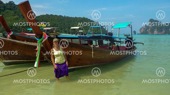 Woman enjoy walking along the water at Krabi Beach, Thailand
