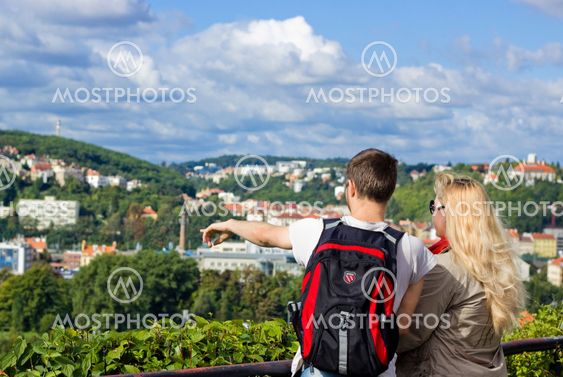 A young couple observing a city