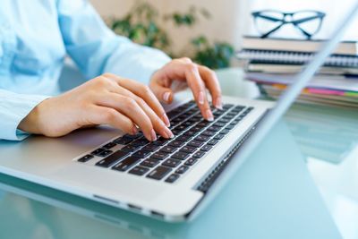 Closeup female hands on laptop keyboard