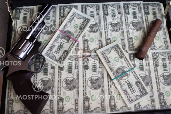 Wedding rings,gun, cigar and money in a case