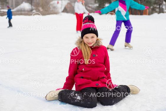 skater girl sitting on the ice