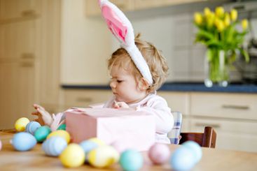 Cute little toddler girl wearing Easter bunny ears...