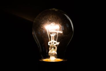 Close-up of electrical bulb on black background