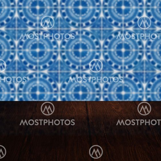Wood table top and blur vintage ceramic tile pattern wall