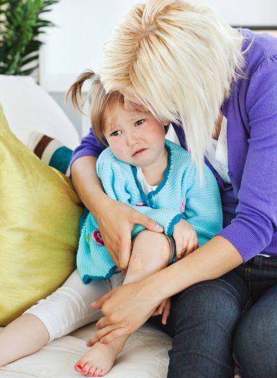 Sick sad child lying on couch