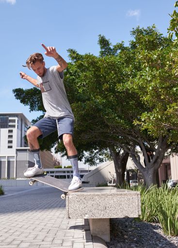 City, jump and man with skateboard, trick and...