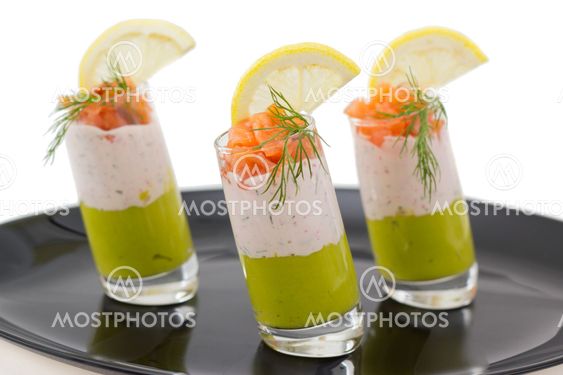 Salmon and avocado mousse on black plate