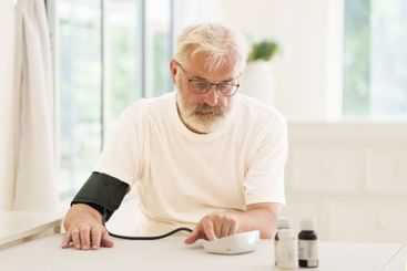 Senior man measuring blood pressure
