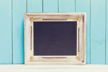 Cozy pastel wooden home decor objects on blue background