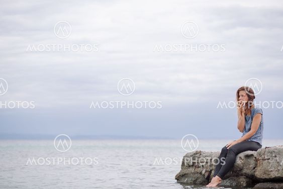Woman alone and depressed at seaside