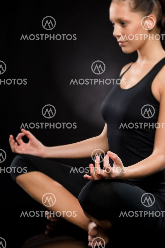 Relaxed young woman exercising in lotus position