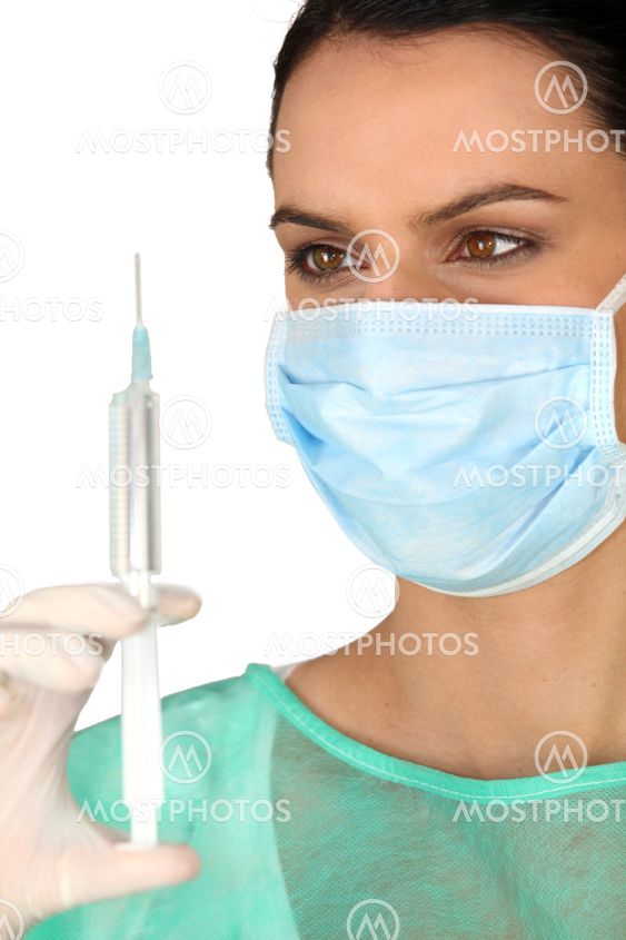 Female surgeon holding syringe