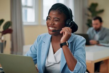 Businesswoman, headset and happy with laptop in office,...