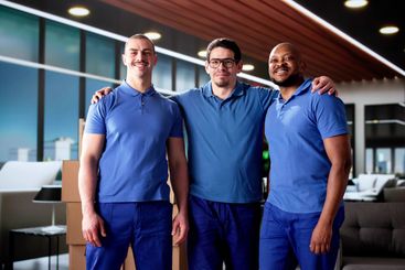 Diverse Team of Professional Movers Relocating a Living