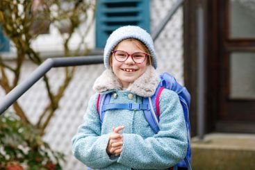 Cute little girl o the way to or from school. Healthy...