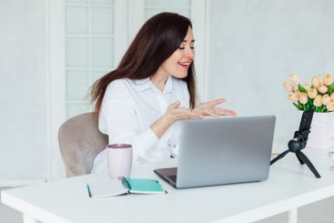 woman brunette sitting at table chatting online business