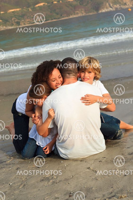 Joyful Family on the beach having fun