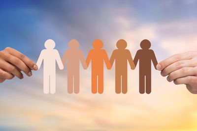 hands holding chain of people pictogram over sky