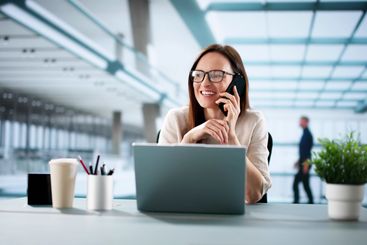 Busy Female Entrepreneur Juggling Calls And Emails