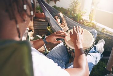 Friends, relax and playing drums for fun, outdoor...