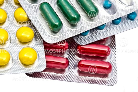 Colorful pills closeup on white background