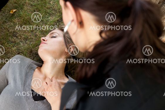 Paramedic Listening to Heart with Stethoscope