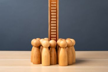 A crowd of people and a ladder going up. The concept of...